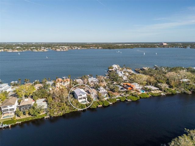 birds eye view of property with a water view