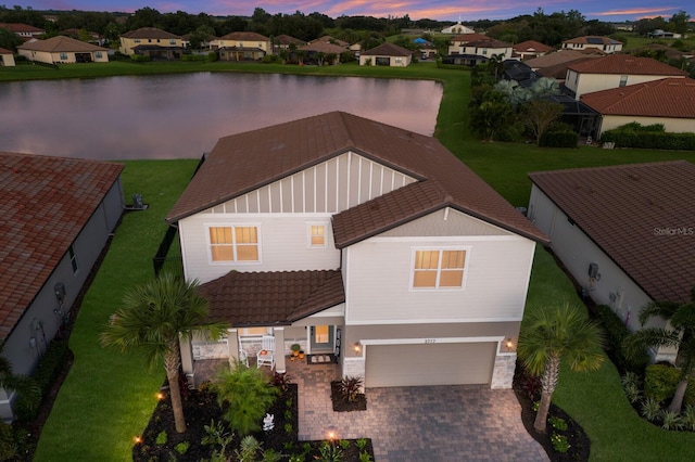 aerial view at dusk with a water view