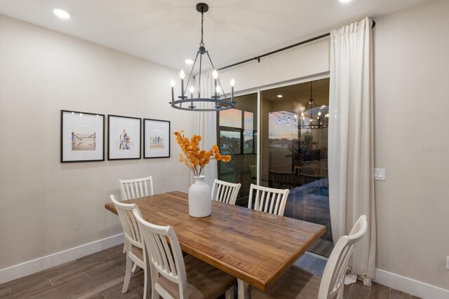 dining area featuring a chandelier and dark hardwood / wood-style floors