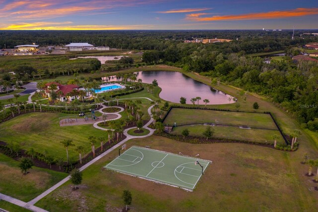 aerial view at dusk featuring a water view