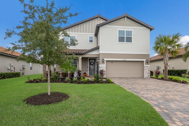 craftsman inspired home featuring a front yard and a garage