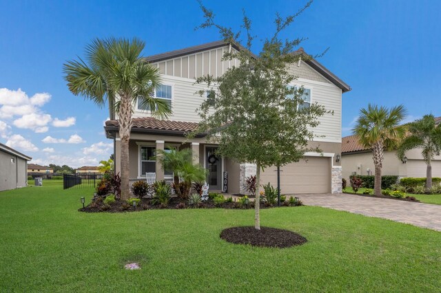 view of front of house with a garage and a front lawn