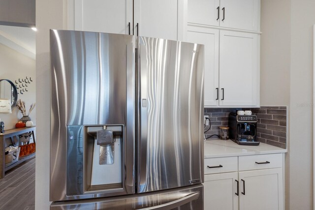 kitchen featuring white cabinets, light stone countertops, dark wood-type flooring, and stainless steel fridge with ice dispenser