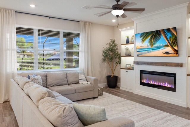 living room with hardwood / wood-style floors and ceiling fan