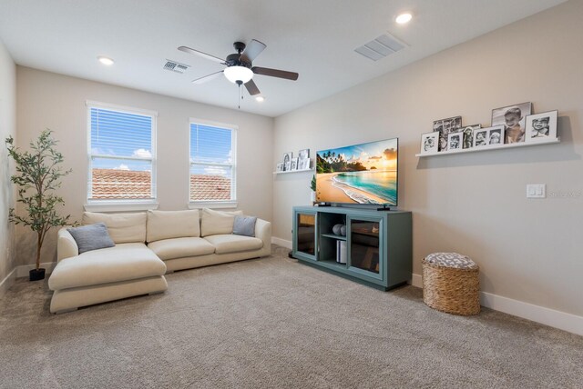 living room with ceiling fan and carpet floors