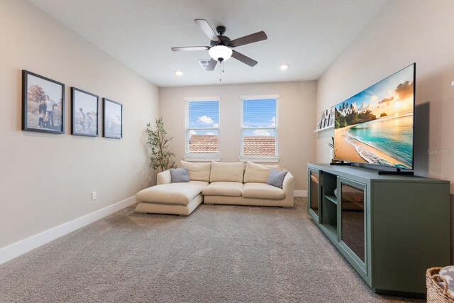 carpeted living room featuring ceiling fan