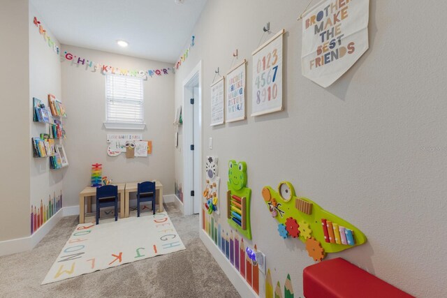 recreation room with carpet flooring