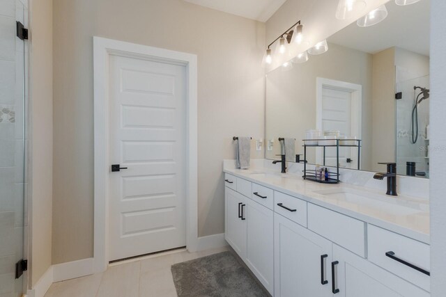 bathroom with walk in shower, vanity, and tile patterned flooring