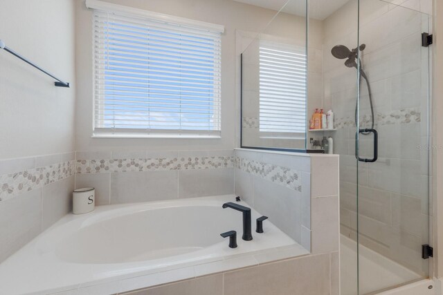 bathroom with shower with separate bathtub