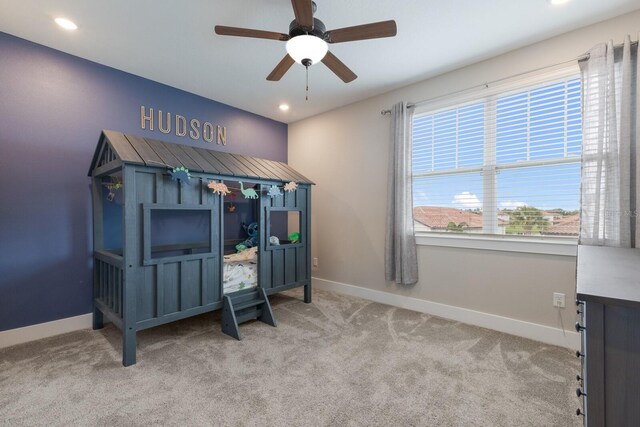 interior space with light carpet and ceiling fan