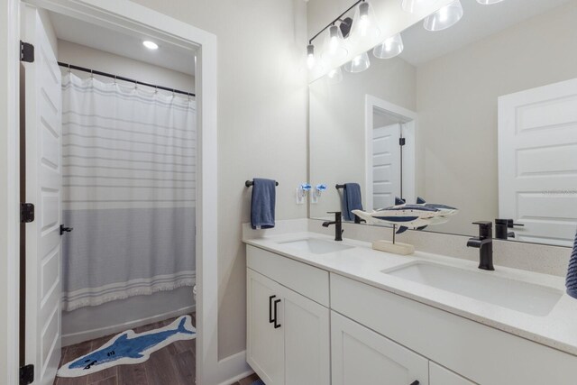 full bathroom featuring vanity, shower / bath combo with shower curtain, toilet, and hardwood / wood-style flooring