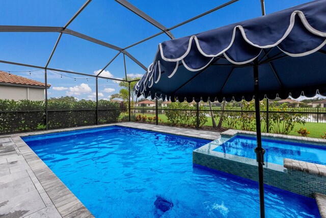 view of pool with a water view and a lanai