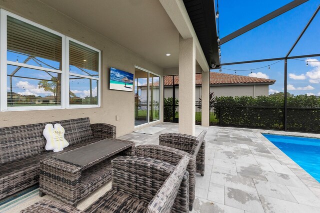 view of patio / terrace featuring glass enclosure