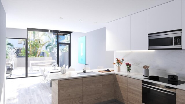 kitchen with white cabinets, plenty of natural light, and stainless steel appliances