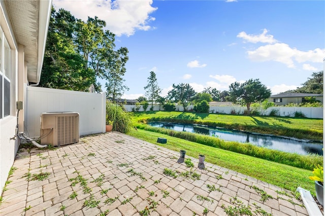 view of patio / terrace featuring central air condition unit and a water view