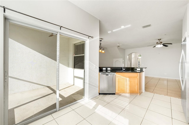 kitchen with hanging light fixtures, light tile patterned flooring, stainless steel appliances, and light brown cabinetry