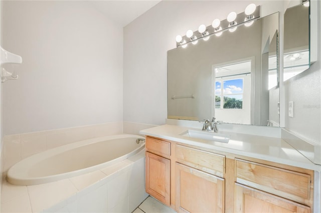 bathroom with tile patterned floors, tiled bath, and vanity