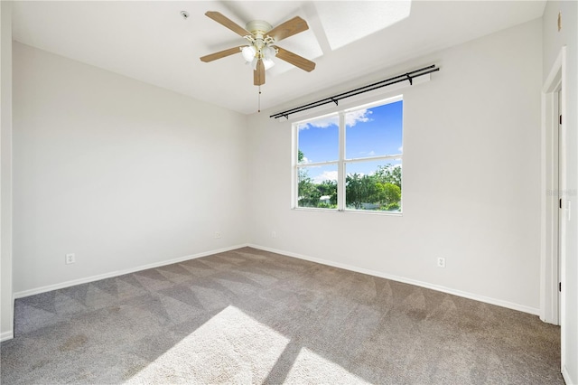 carpeted spare room featuring ceiling fan