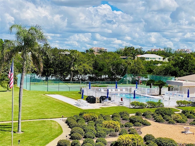 view of community featuring a lawn, tennis court, and a pool