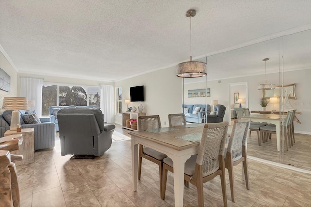 dining room with a textured ceiling and crown molding