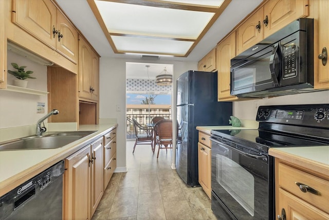 kitchen with light brown cabinetry, sink, black appliances, light tile patterned floors, and an inviting chandelier