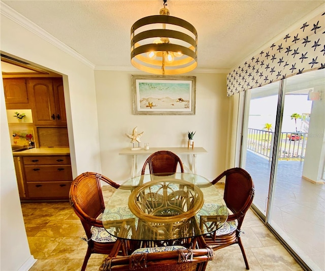 tiled dining space featuring a textured ceiling, an inviting chandelier, and ornamental molding