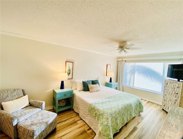 bedroom with ceiling fan, crown molding, a textured ceiling, and light wood-type flooring