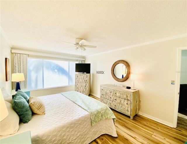 bedroom with ceiling fan, crown molding, a textured ceiling, and light wood-type flooring