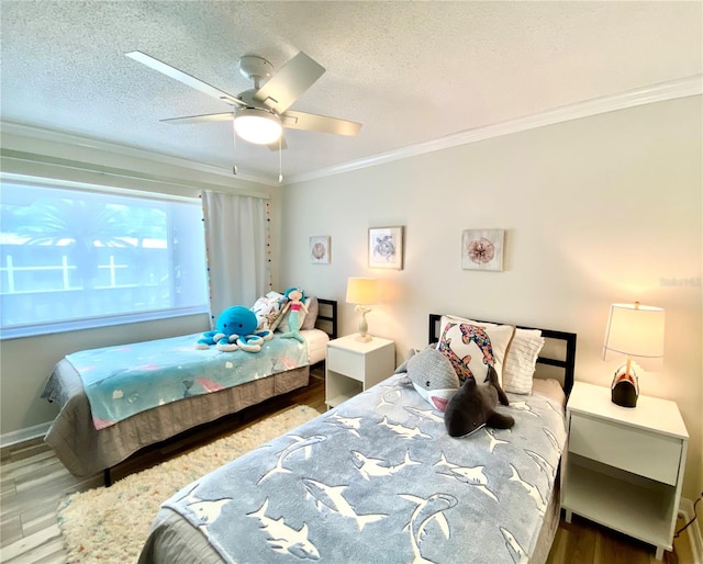 bedroom featuring ceiling fan, hardwood / wood-style floors, a textured ceiling, and ornamental molding