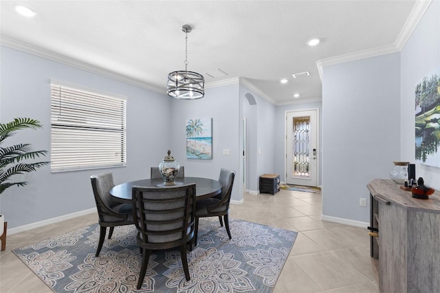 tiled dining area with ornamental molding and a chandelier