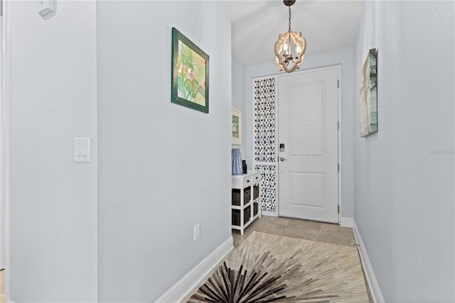 foyer entrance with a notable chandelier and light tile patterned floors