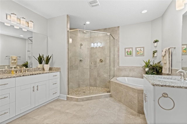 bathroom with vanity, plus walk in shower, and tile patterned flooring