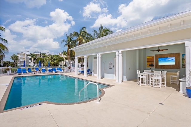 view of swimming pool with ceiling fan and a patio area