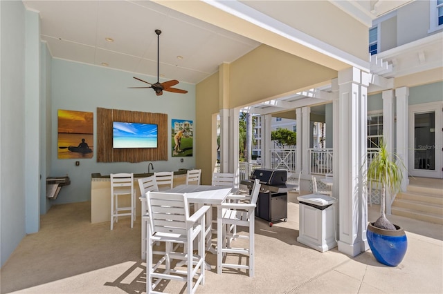 view of patio / terrace featuring ceiling fan and an outdoor bar