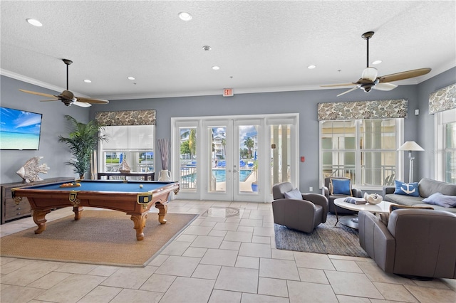 game room with light tile patterned flooring, ornamental molding, french doors, a textured ceiling, and billiards