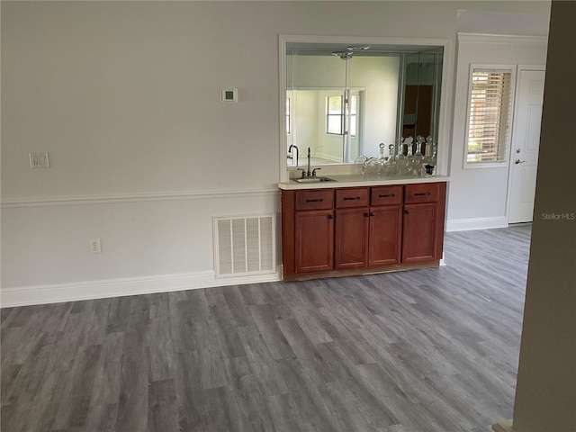 7861 Pine Trace Dr Unit 7861, Sarasota, FL 34243 - kitchen with dark wood-type flooring, baseboards, light countertops, a sink, and reddish brown cabinets