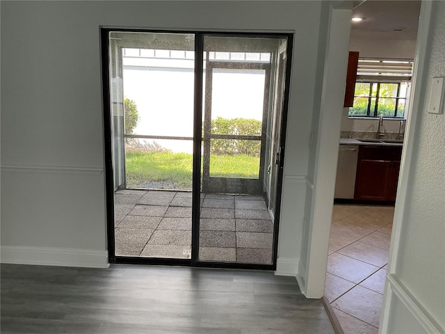 7861 Pine Trace Dr Unit 7861, Sarasota, FL 34243 - doorway with a sink, wood finished floors, and baseboards