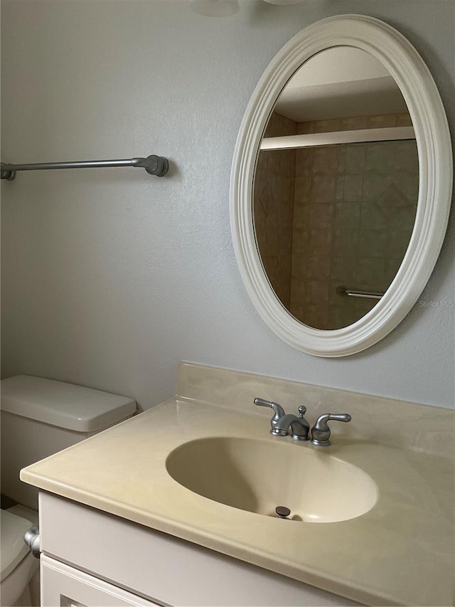 full bath featuring toilet and vanity