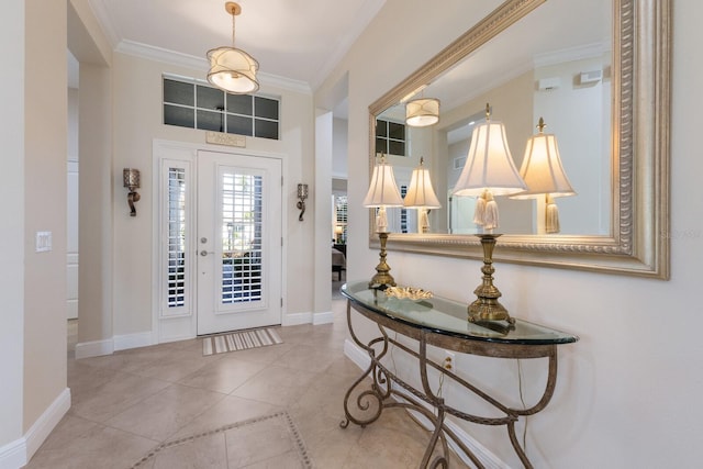 tiled foyer entrance featuring crown molding