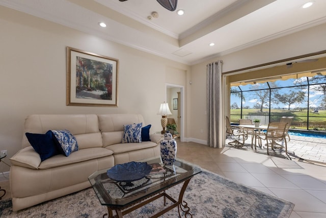 tiled living room with ceiling fan and crown molding