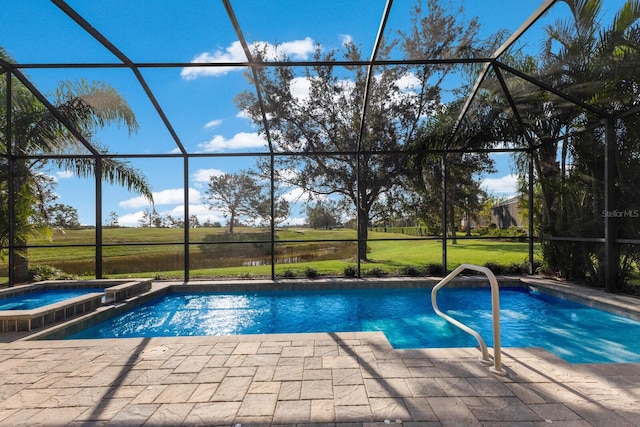 view of swimming pool featuring glass enclosure, an in ground hot tub, a yard, and a patio