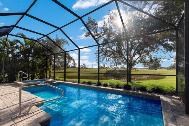 view of pool featuring a hot tub and glass enclosure