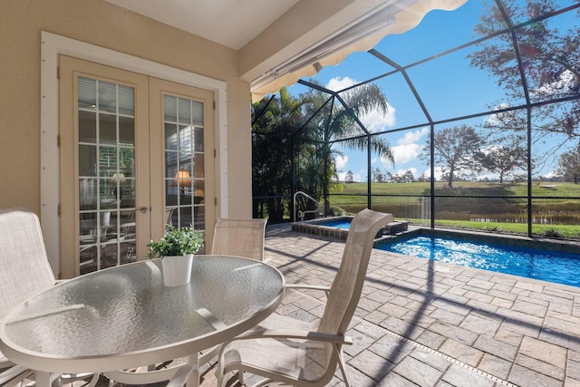 view of pool featuring glass enclosure, a patio area, and an in ground hot tub