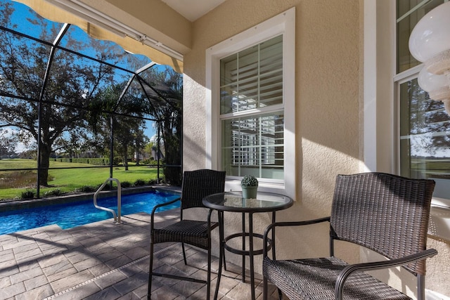 view of swimming pool with a yard, a patio area, and a lanai