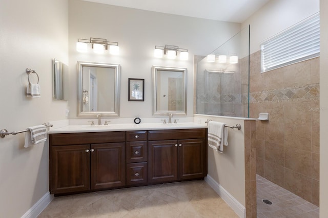 bathroom with a tile shower and vanity