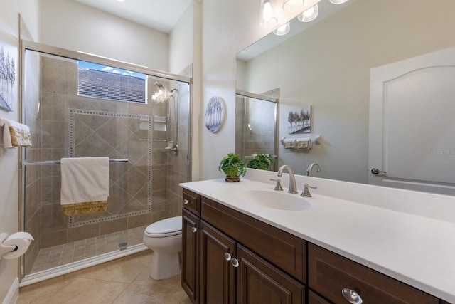 bathroom featuring tile patterned floors, vanity, toilet, and walk in shower