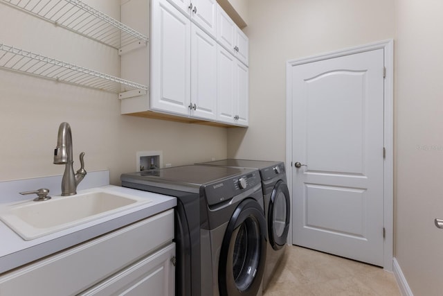 laundry area with cabinets, sink, and washer and dryer