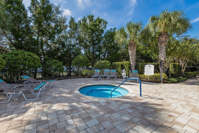 view of pool with a patio area and a hot tub