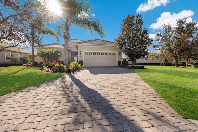 view of front of property with a garage and a front yard