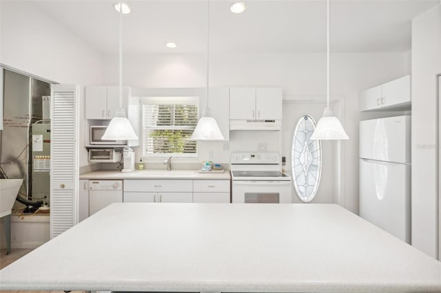 kitchen featuring hanging light fixtures, white appliances, and white cabinets